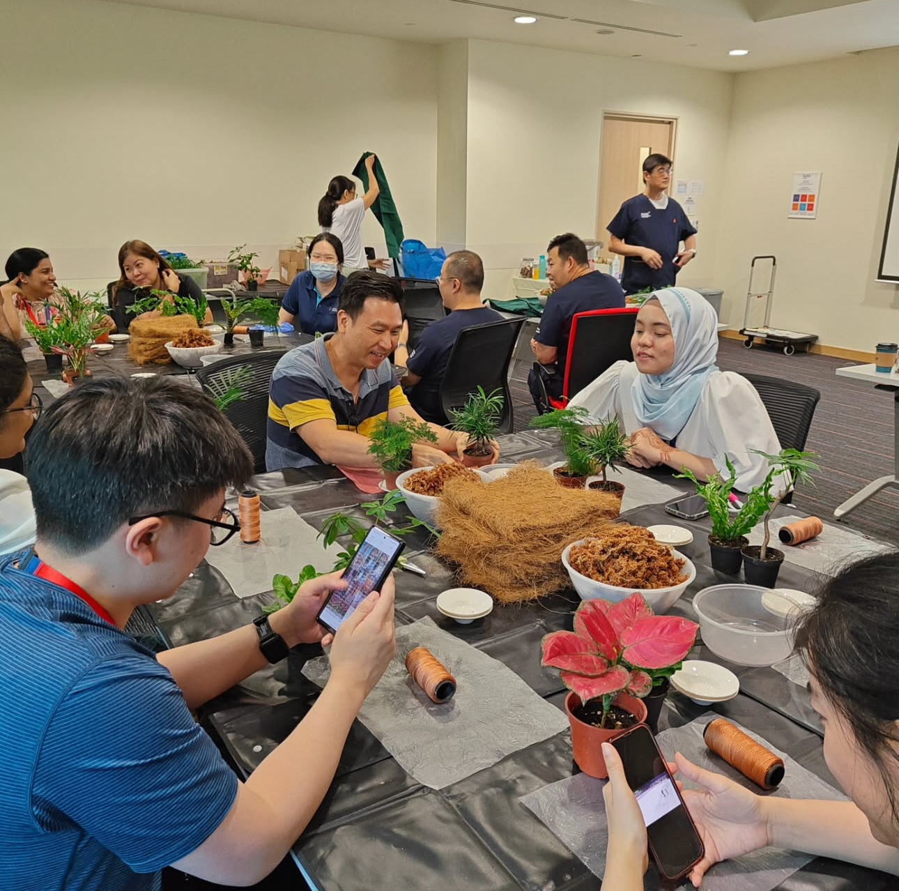 Colleagues making kokedama during a team-building workshop