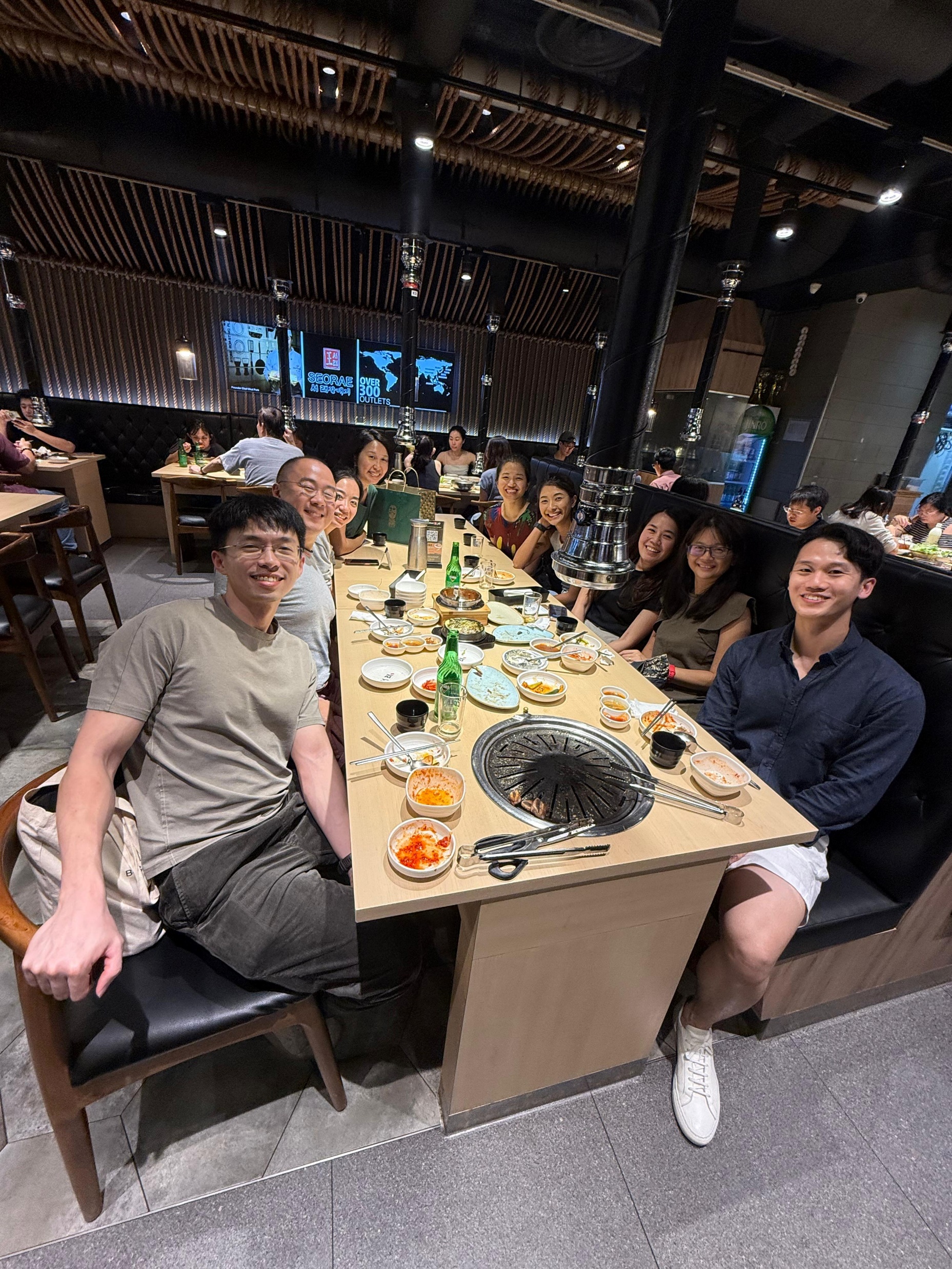 Residents and faculty gathered around a restaurant table